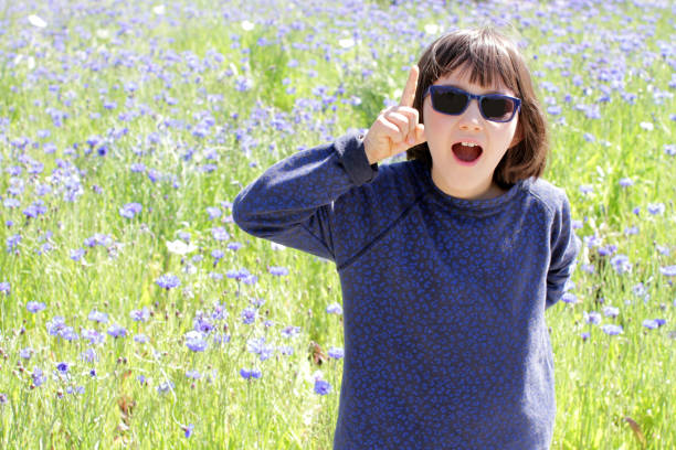 istock happy excited child with blue sunglasses expressing playful natural creativity 1176740009