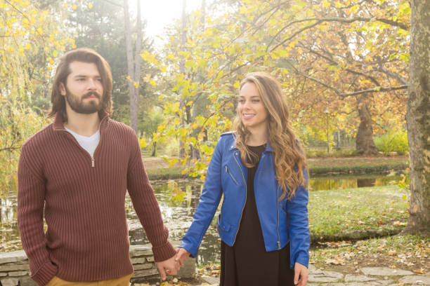 istock Couple in the park enjoying nice autumn time. 1176740015
