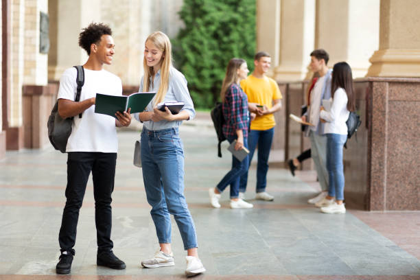istock Happy classmates preparing for lecture in university campus 1176740060