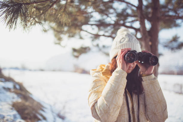 istock woman hiker looking into binoculars 1176741031
