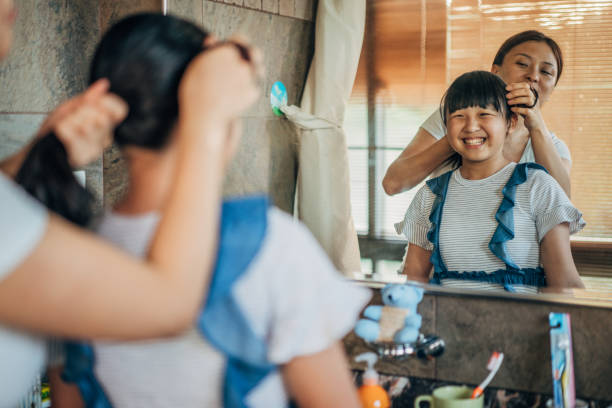 istock Mom and daughter in bathroom 1176741631