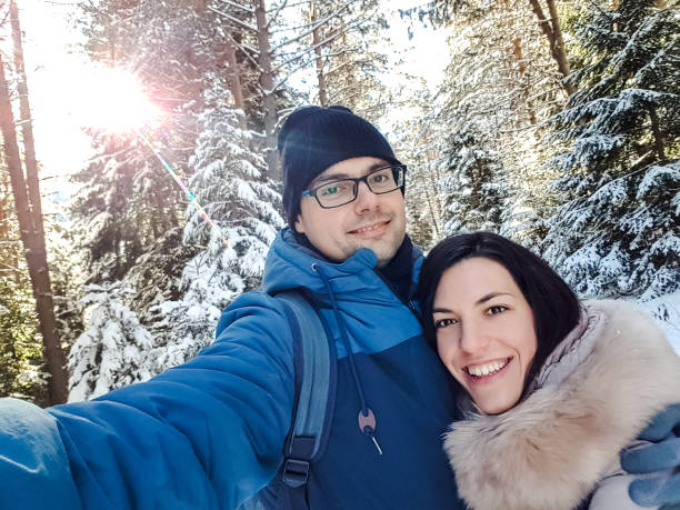 istock Loving couple enjoying snowy mountain 1176742909