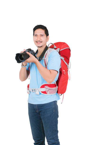 istock Asian man with a backpack holding a camera to take pictures 1176744265