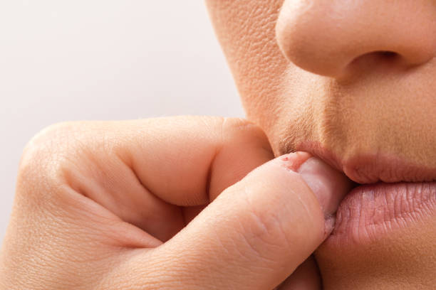 istock Woman bitting her fingers 1176744286