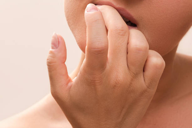 istock Woman bitting her fingers 1176744472