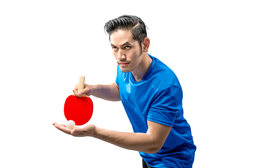 Asian table tennis player man in serving position isolated over white background
