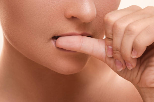istock Woman bitting her fingers 1176745338