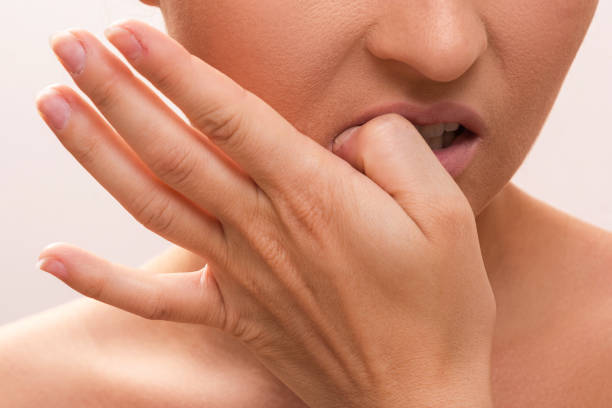 istock Woman bitting her fingers 1176745392