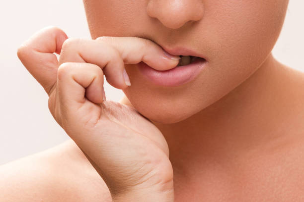 istock Woman bitting her fingers 1176745502