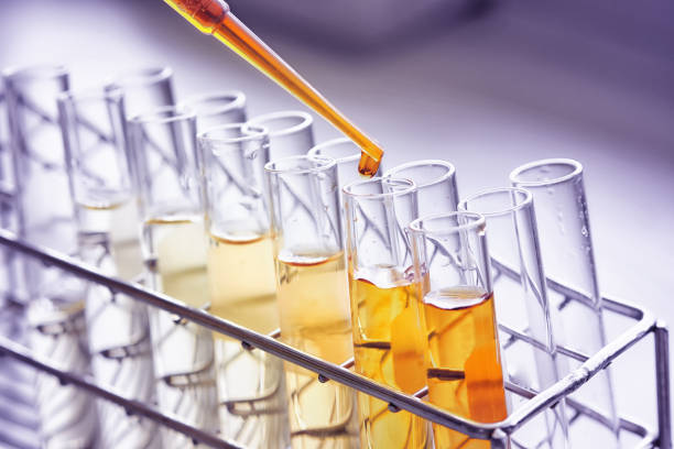 equipment and glassware for test product extraction and orange color solution, in the chemistry laboratory. stock photo