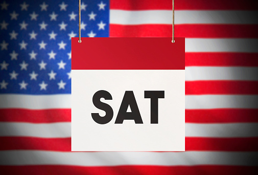 Calendar standing in front of the American flag and showing Saturday Stock Image