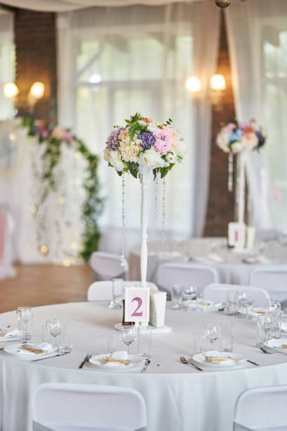 istock Plates with glasses on a table with a white tablecloth 1176748414