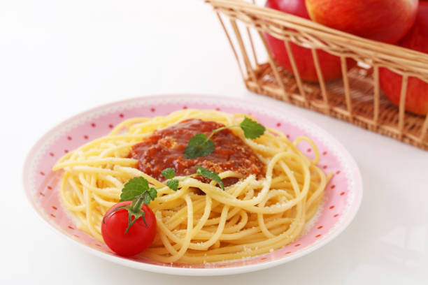 Italian food - spaghetti and cherry tomatoes on the with background