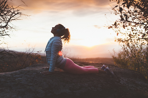Woman exercising on sunset