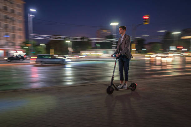 istock Man riding e-scooter on the street at night 1176752731