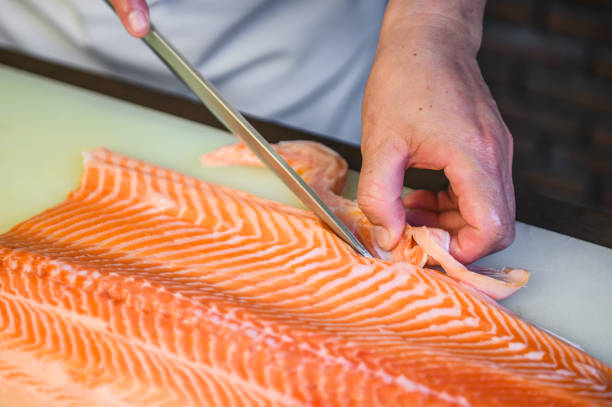 istock close up chef cutting fresh salmon 1176752770