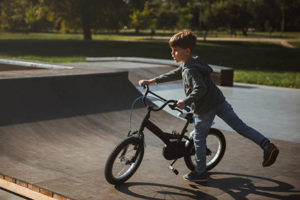 istock Boy riding bicycle in skate park 1176753054