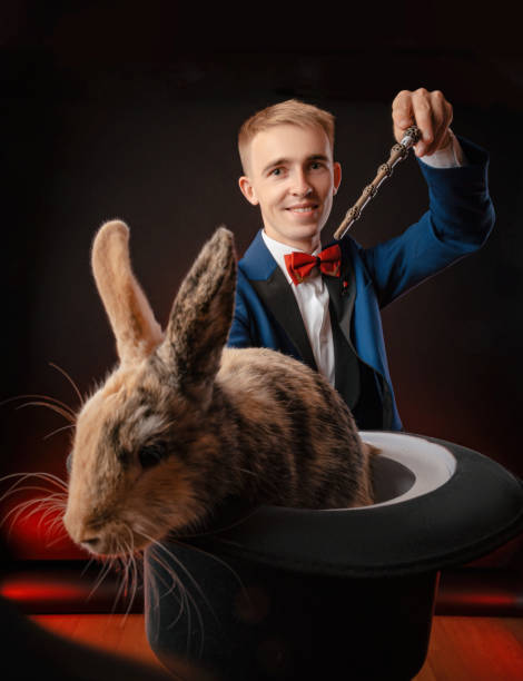 istock a young guy magician illusionist holding a hat with a rabbit 1176753943
