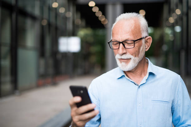 istock Senior businessman using a smart phone outdoors on a break. 1176754300