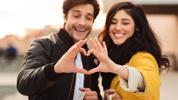 istock Romantic couple making heart shape with hands 1176757369