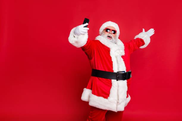 istock Portrait of his he nice attractive cheerful cheery positive glad friendly hospitable bearded Santa pouted lips taking making selfie blog blogger isolated over bright vivid shine red background 1176757549