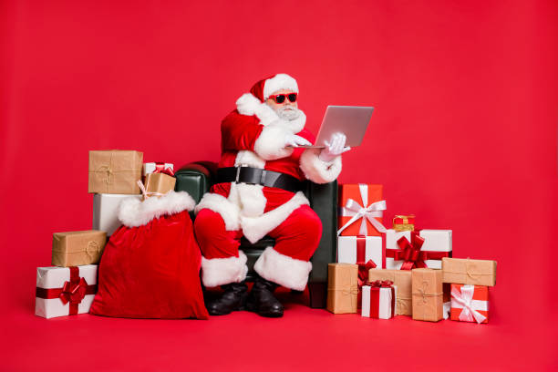 istock Nice focused hard-working fat bearded man sitting delivering many different purchases shop delivery checking address list wi-fi clients isolated on bright vivid shine red background 1176757596