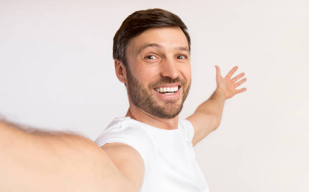 istock Guy Taking Selfie Showing View Behind Him, Studio Shot, Isolated 1176758039