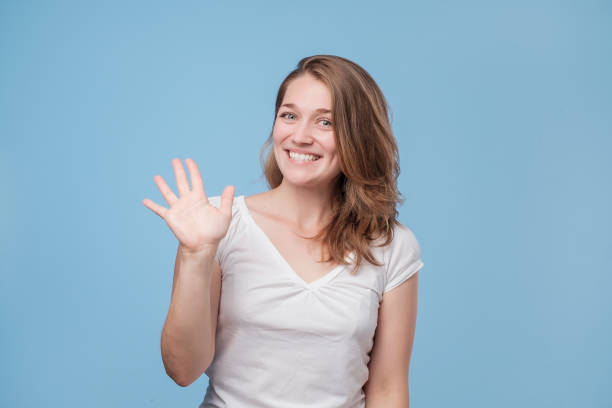 istock woman smiling happily, saying Hello, Hi or Bye 1176758840
