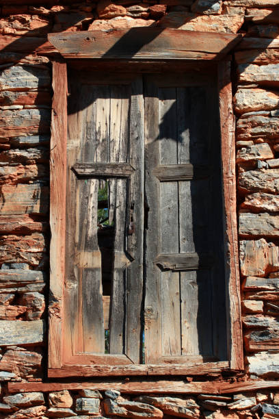 istock stone wall and broken old wood door 1176759122