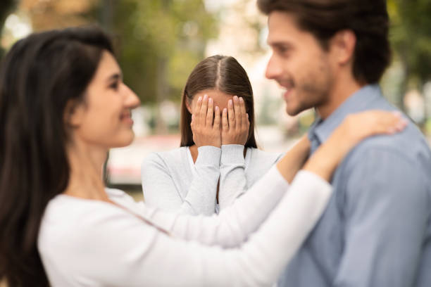 Woman crying, watching her ex boyfriend starts happy love relations New love. Woman crying, watching her ex boyfriend starts happy love relations, park background jealous ex girlfriend stock pictures, royalty-free photos & images