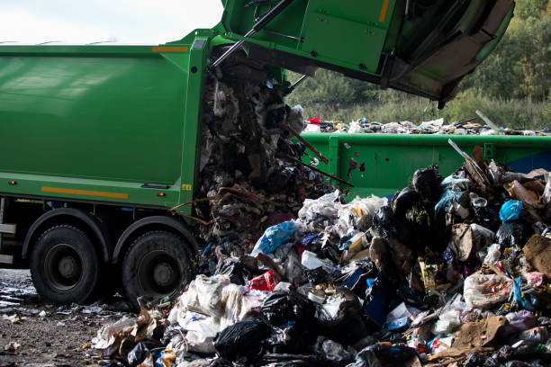 istock Truck tipping garbage from container on junk yard 1176760707