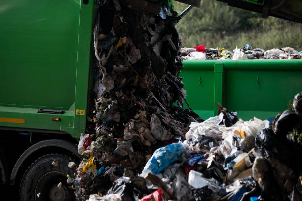 istock Truck tipping garbage from container on junk yard 1176760715