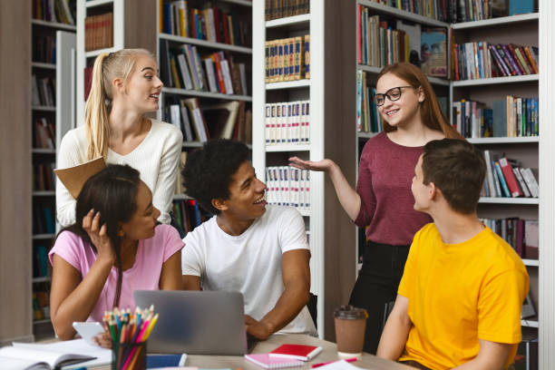 istock Friends doing homework at library together, sharing opinions 1176760786