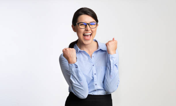 happy businesswoman gesturing yes celebrating success, white background - women standing fist success imagens e fotografias de stock