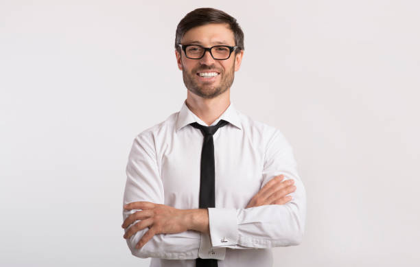 istock Businessman Smiling At Camera Crossing Hands, Studio Shot 1176760997