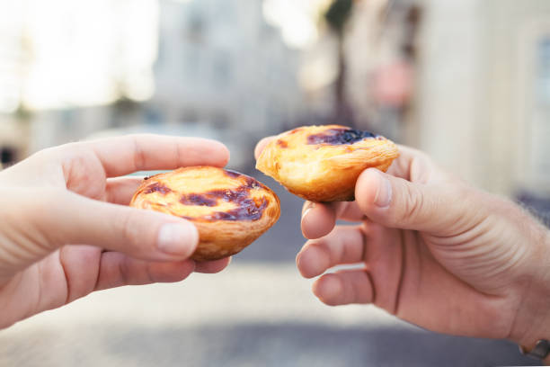 Traditional portuguese dessert. Traditional portuguese desserts in woman's and man's hands. Pastel de Nata. pasteis de belem stock pictures, royalty-free photos & images