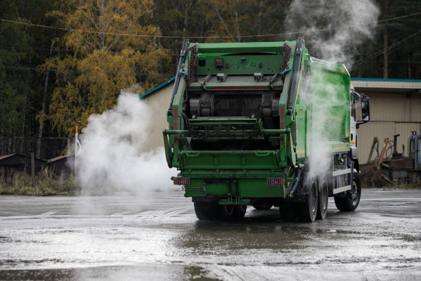 Garbage truck caught in action disposing trash. stock photo