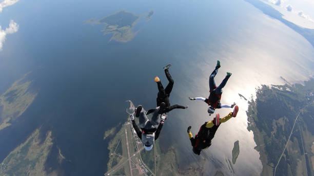 istock Skydivers fall through clear skies, in aerial flight 1176763620