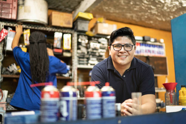 portrait of a mechanic working in a auto repair shop - automotive accessories imagens e fotografias de stock