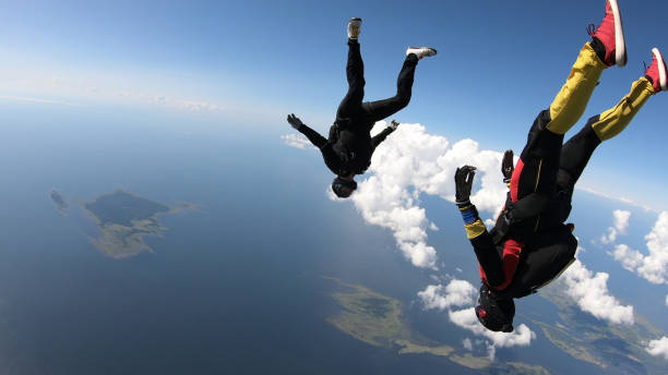 istock Skydivers fall through clear skies, in aerial flight 1176763839