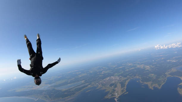 istock Skydiver falls through clear skies, in aerial flight 1176764362