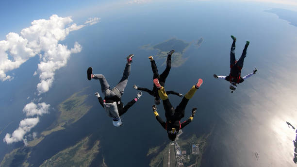 istock Skydivers fall through clear skies, in aerial flight 1176764497