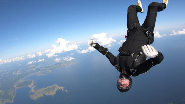istock Skydiver falls through clear skies, in aerial flight 1176764747