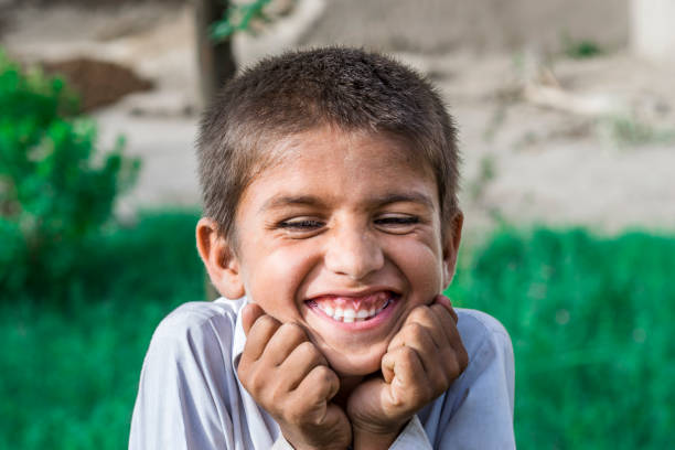 istock a poor homeless happy smiling orphan child 1176766198
