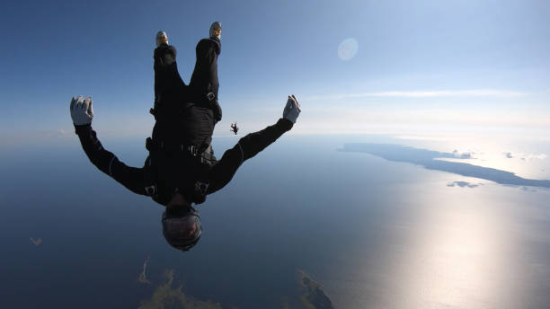 istock Skydivers fall through clear skies, in aerial flight 1176766484