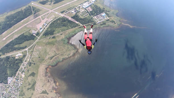 istock Skydiver falls through clear skies, in aerial flight 1176766707