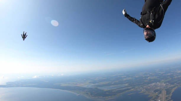 istock Skydivers fall through clear skies, in aerial flight 1176767126