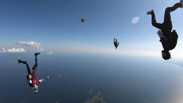 istock Skydivers fall through clear skies, in aerial flight 1176767925
