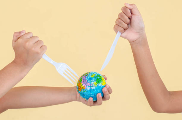 istock Plastic steak knife and plastic fork are destroying the globe, which is concept of global environment from plastic. 1176768469