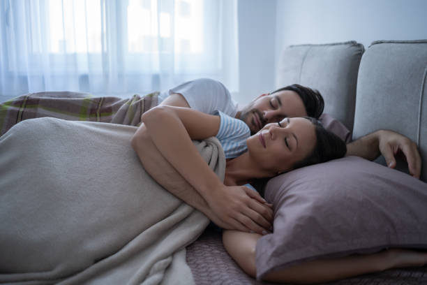 pareja durmiendo - stretching boyfriend indoors lifestyles fotografías e imágenes de stock